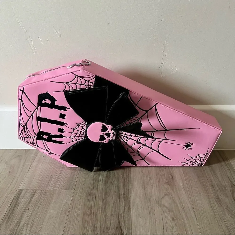 Dolls Kill oversize pink and black skull spiderweb coffin backpack. New in box